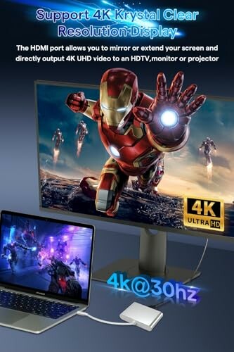 Monitor displaying 4K superhero image with laptop connection.