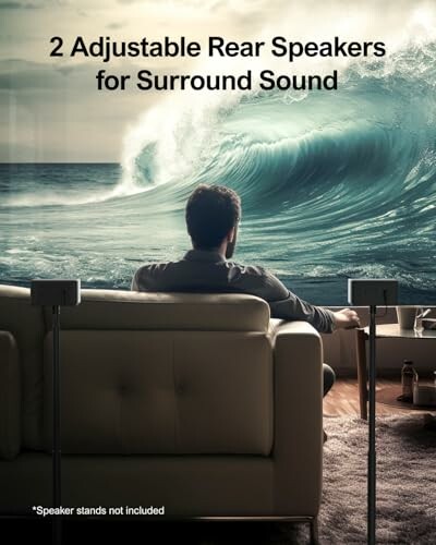 Man on sofa with rear speakers, facing a large ocean wave on screen.