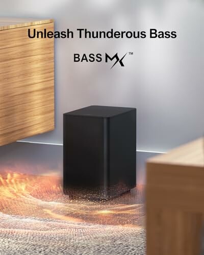 Black speaker with glowing bass effect and text 'Unleash Thunderous Bass Bass MX'.