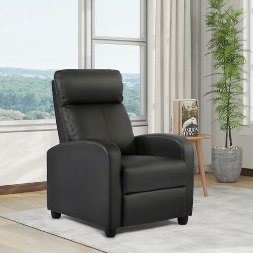 Black recliner chair in a living room with a window and plant