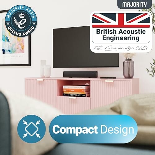 Compact audio system with British Acoustic Engineering award displayed on a pink cabinet.