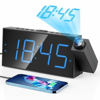 Digital alarm clock projecting time with smartphone charging.