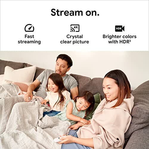 Family streaming TV together on a couch