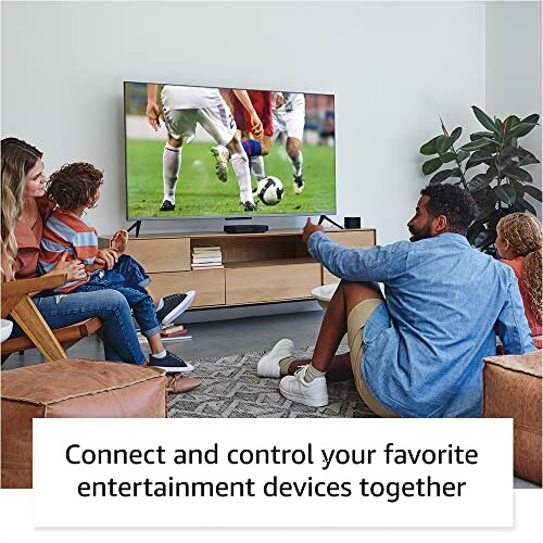 Family watching soccer on TV in living room