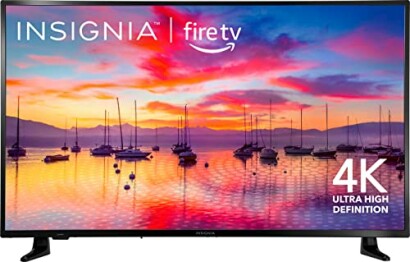 Insignia Fire TV displaying a sunset over a lake with sailboats, featuring 4K Ultra High Definition.