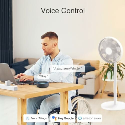 Man in wheelchair using voice control with smart speaker to operate fan.