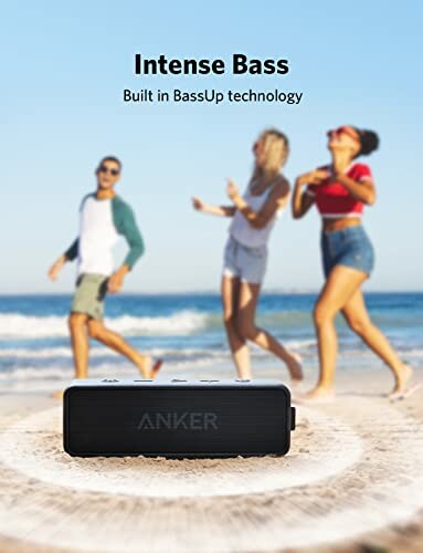 Anker portable speaker on beach with people dancing