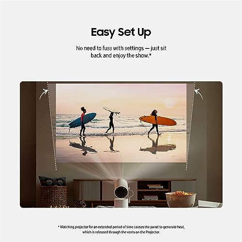 Projector setup displaying surfers on a beach.