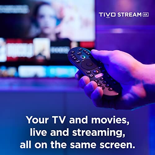 Hand holding a TiVo Stream remote control in front of a TV screen.